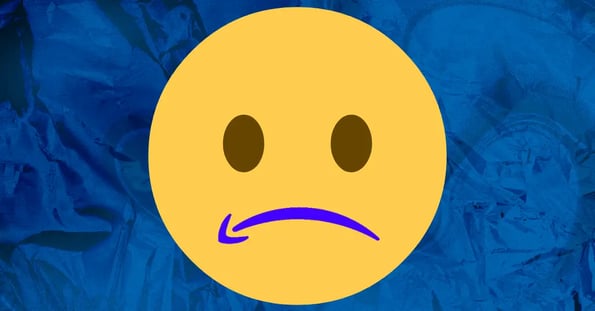 On a blue background, a large yellow frowning face emoji, with Amazon’s arrow logo making up the mouth.